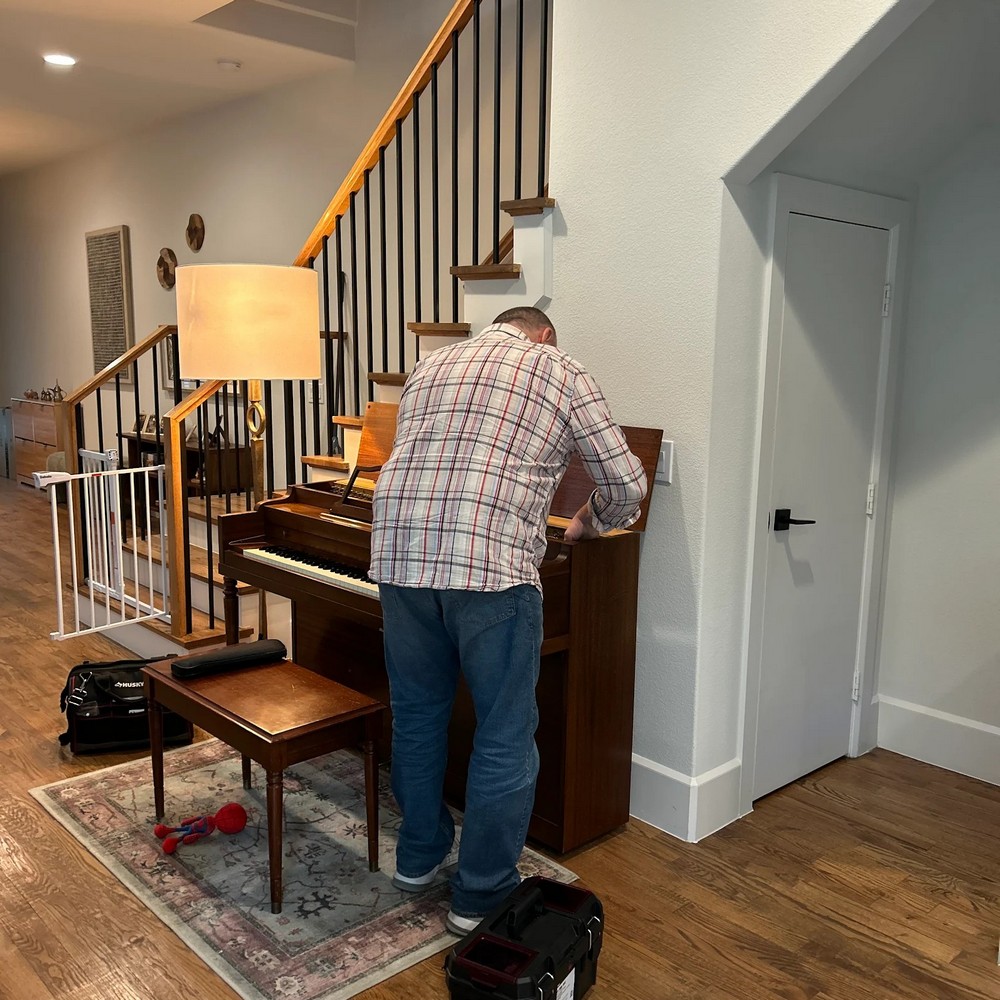 Dmitry working on upright piano