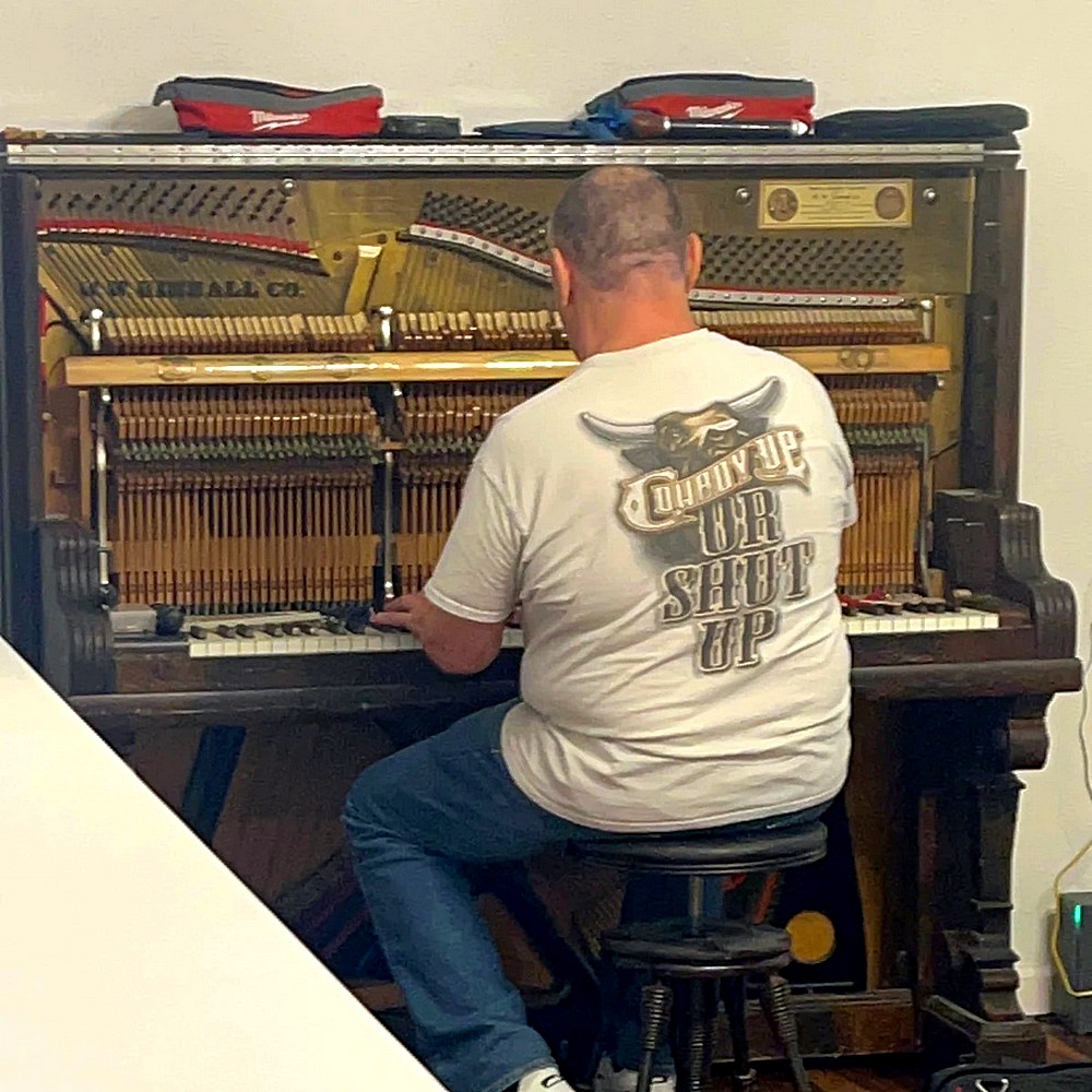 Dmitry working on piano interior