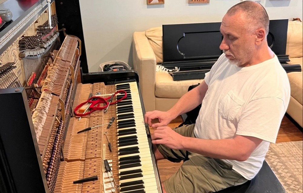 Dmitry servicing a Steinway grand piano